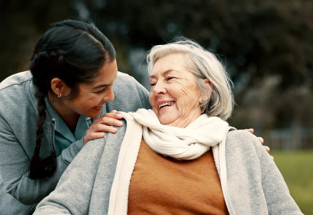 Grandmother laughing and smiling at granddaughter